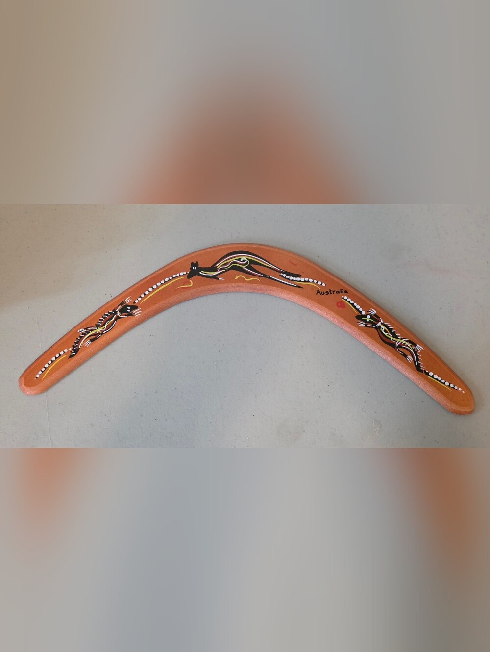 Hand-Painted Orange Boomerang with Aboriginal Motif